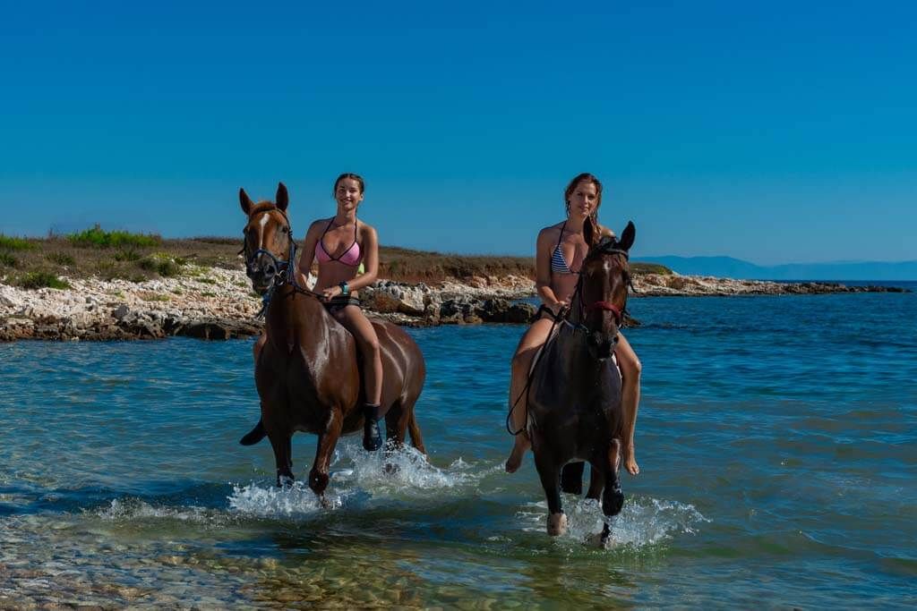 Riders on horses in the sea
