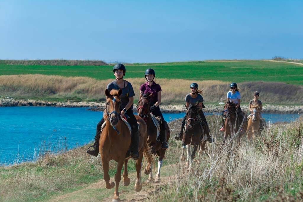 Riders riding by the seaside